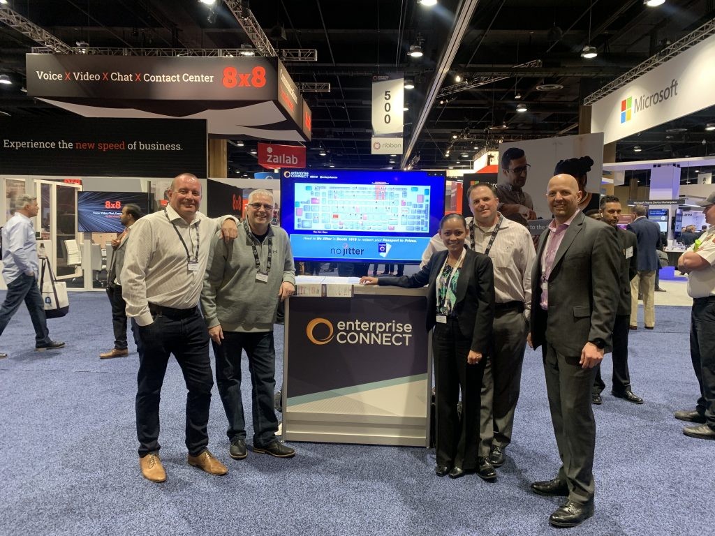 Group of employees in front of Enterprise Connect booth