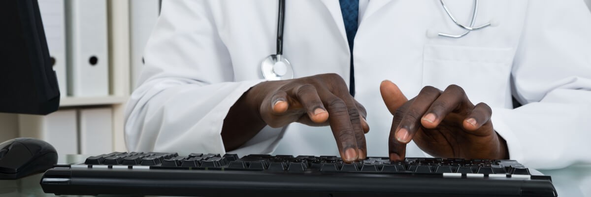 Doctor's hands typing on a keyboard