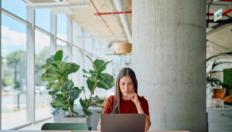 Girl working on a laptop in office