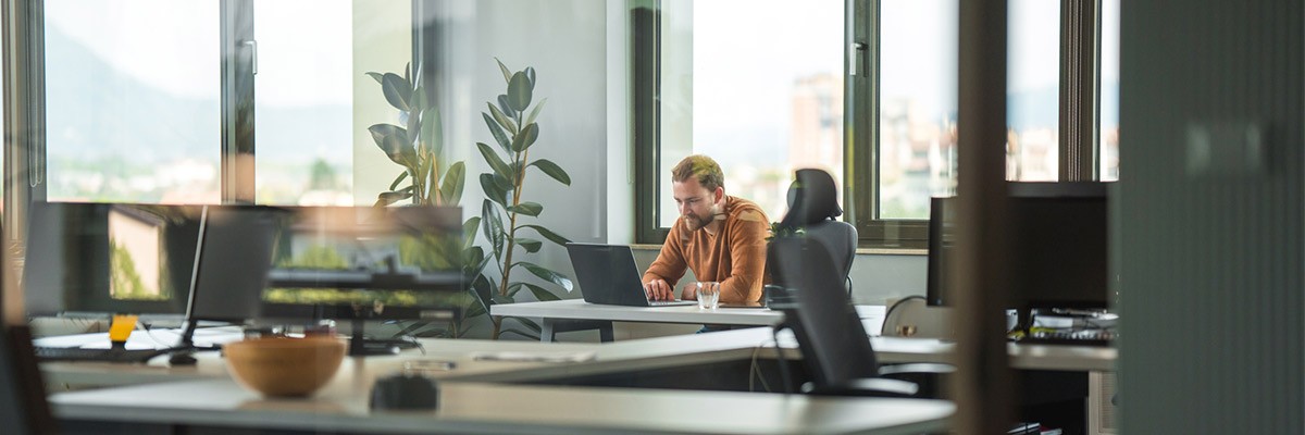 Optimize Your Hybrid Cloud Solution With Cisco+ Businessman working on a laptop