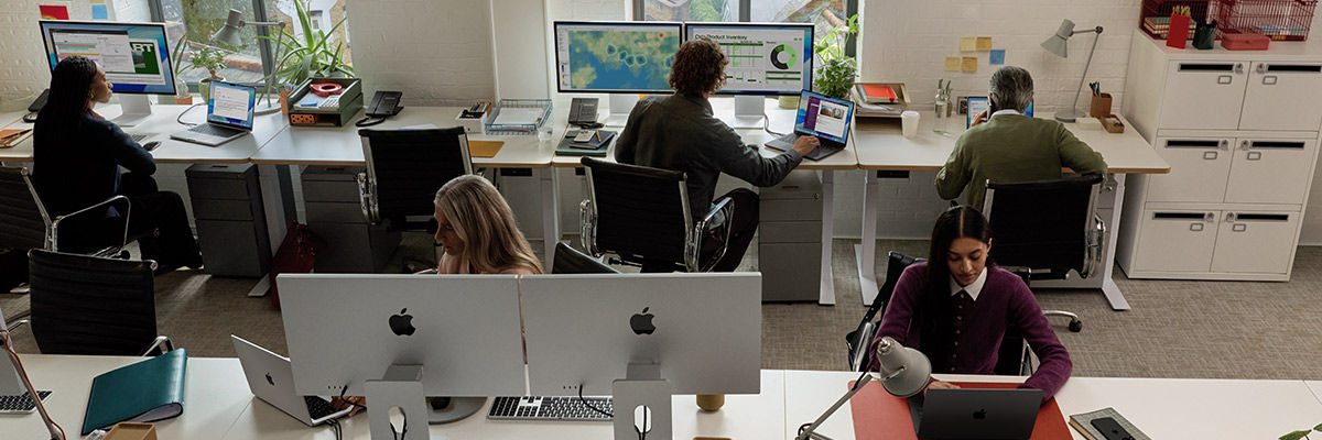 Power AI-Driven Work Experiences With Mac Team in office working on Apple Mac devices