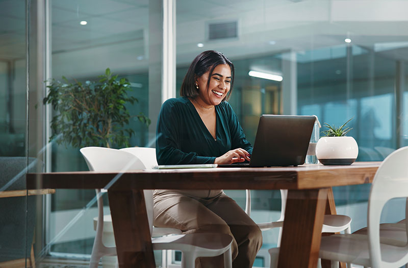 Girl smiling on a laptop