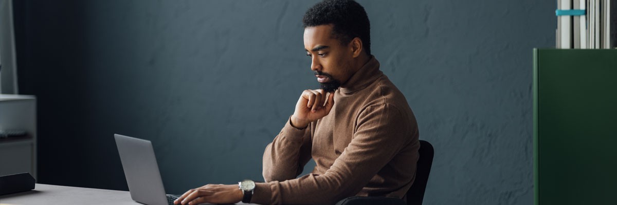Businessman on laptop computer in office