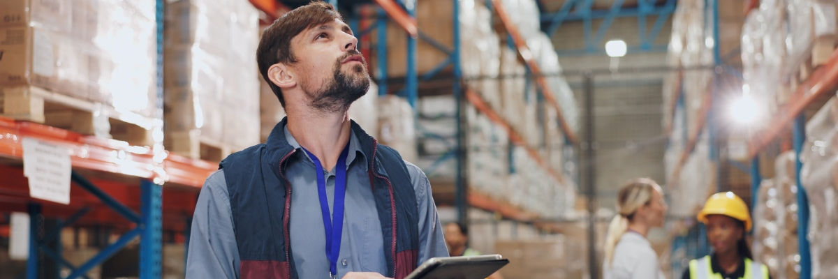 Man in warehouse on a tablet