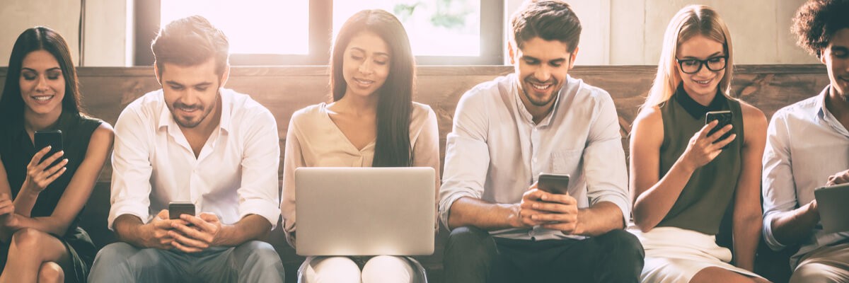 anticipating-user-needs-creating-software-for-humans People standing against a wall using tablet and mobile devices