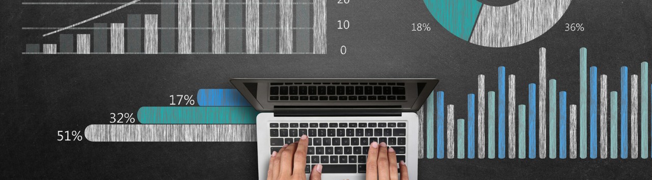 How can we use automation to streamline processes and reduce costs? Laptop and pile of business charts