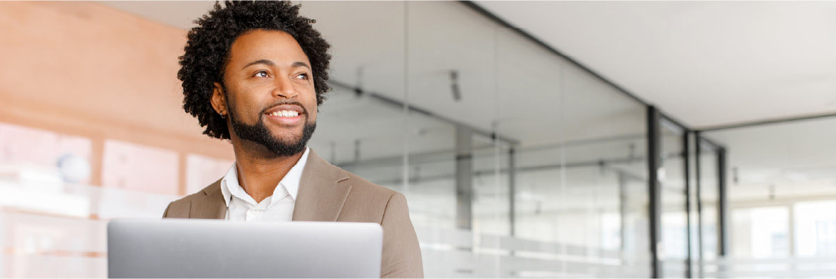 Man smiling at his desktop.