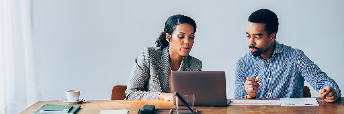 Two people looking at a laptop