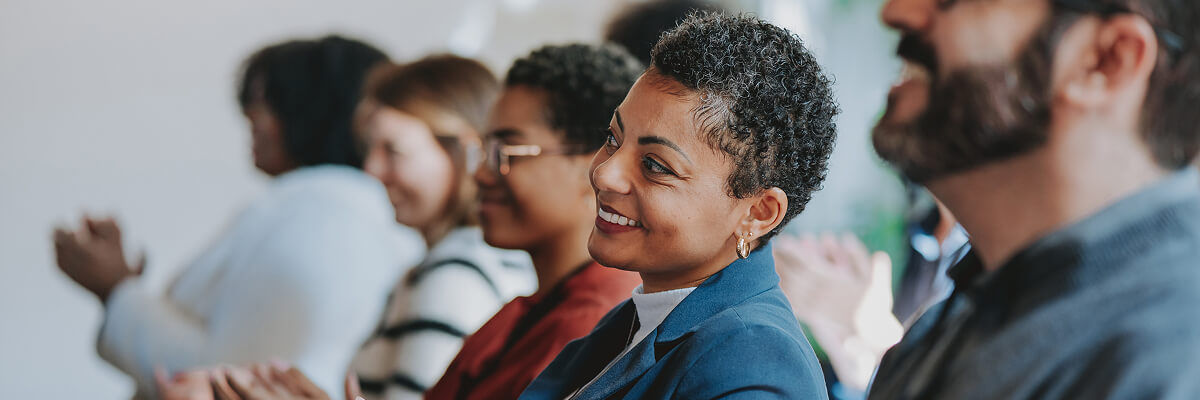 People clapping at a meeting