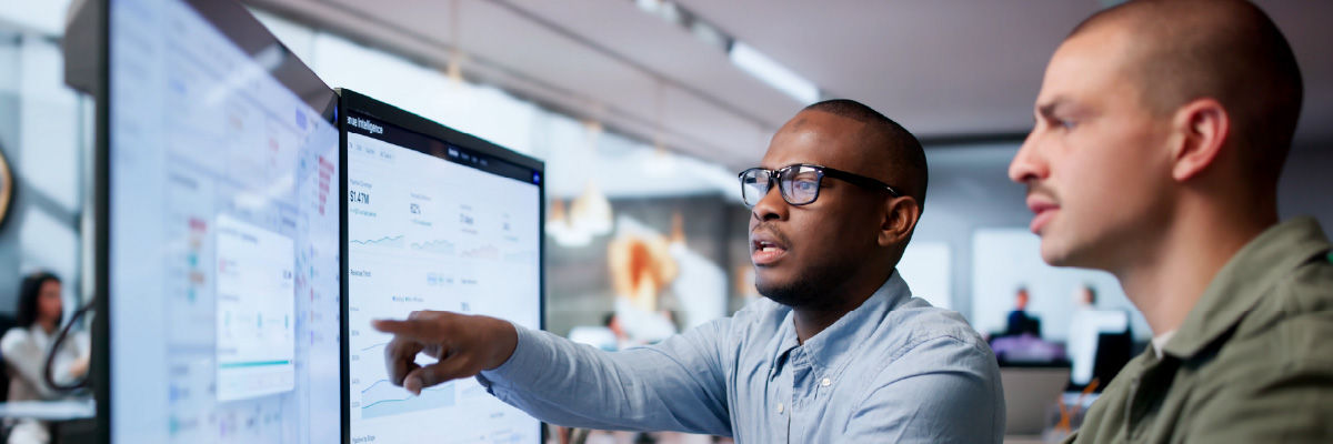 Enterprise AI Governance: How to Stop Shadow Agent Sprawl People coding at work on desktops.