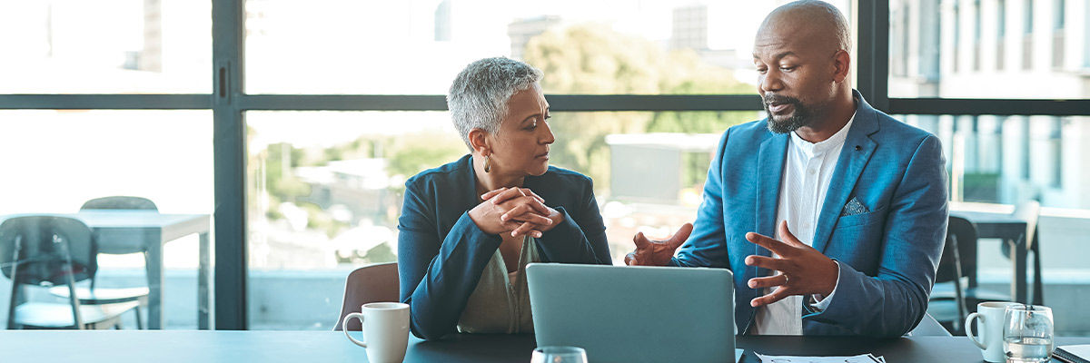 People meeting in front of laptop
