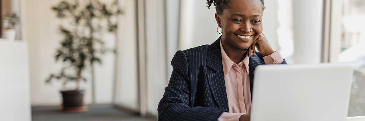 Girl smiling at laptop