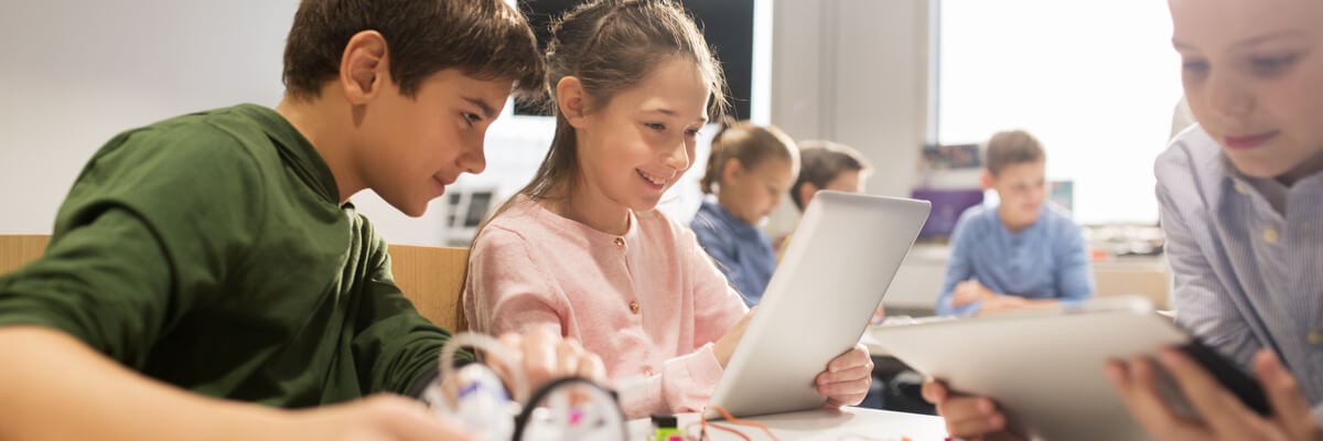 Young students on learning devices in classroom