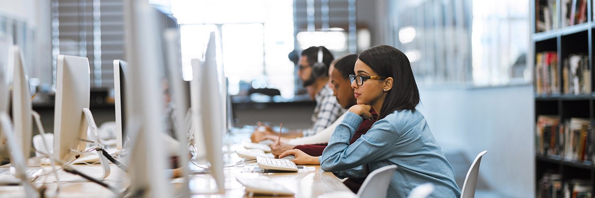 Student in library using technology