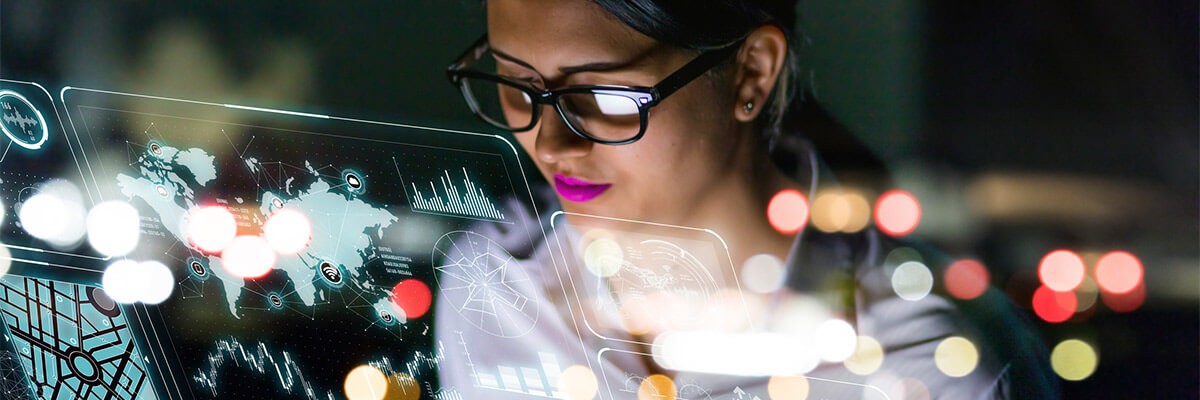 Laying the Groundwork for AI Transformation Through Infrastructure Woman looking at technology graphic overlay