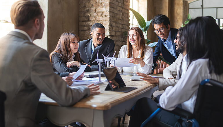 People at a desk smiling