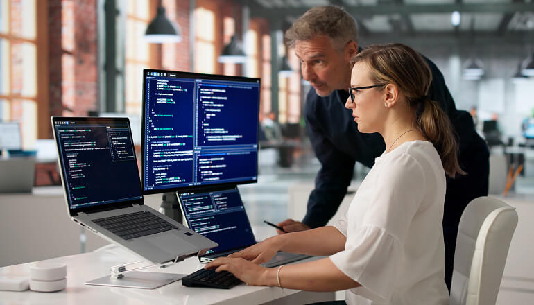 People coding on a laptop.
