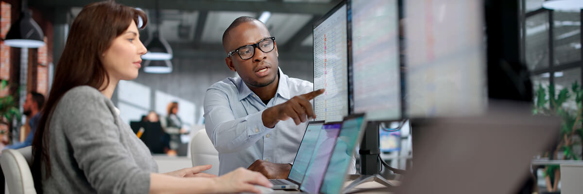 On-Device AI for Business: Real Opportunity or Still Waiting For the ROI? People coding at work on desktops.