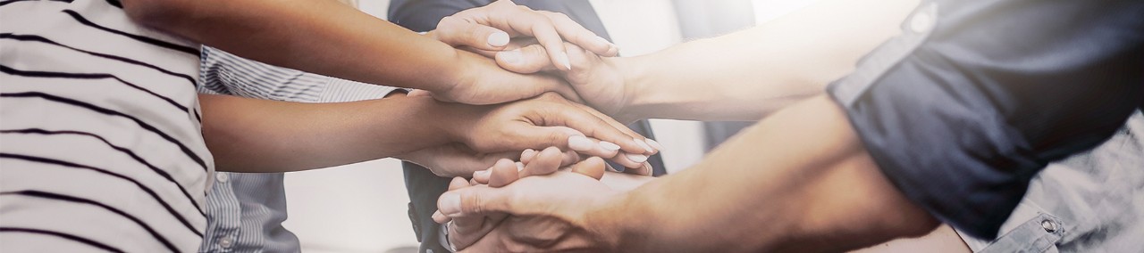Business team put all hands in together to show support