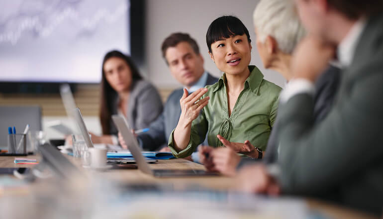 Person talking in a meeting.