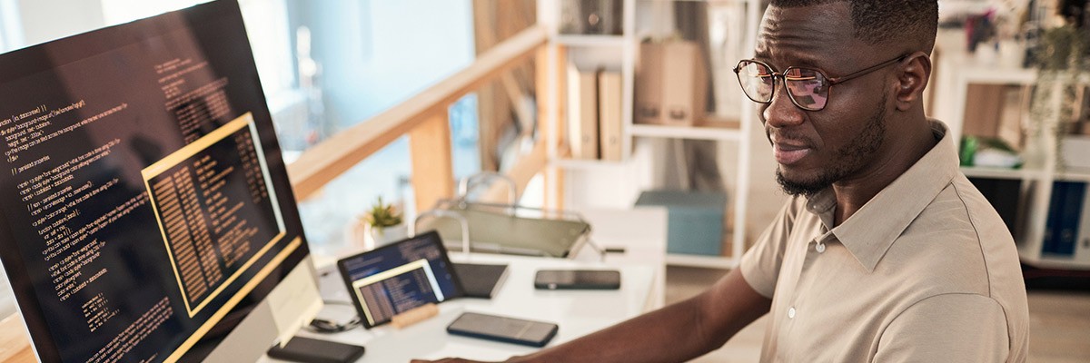 Developer working on monitor at desk