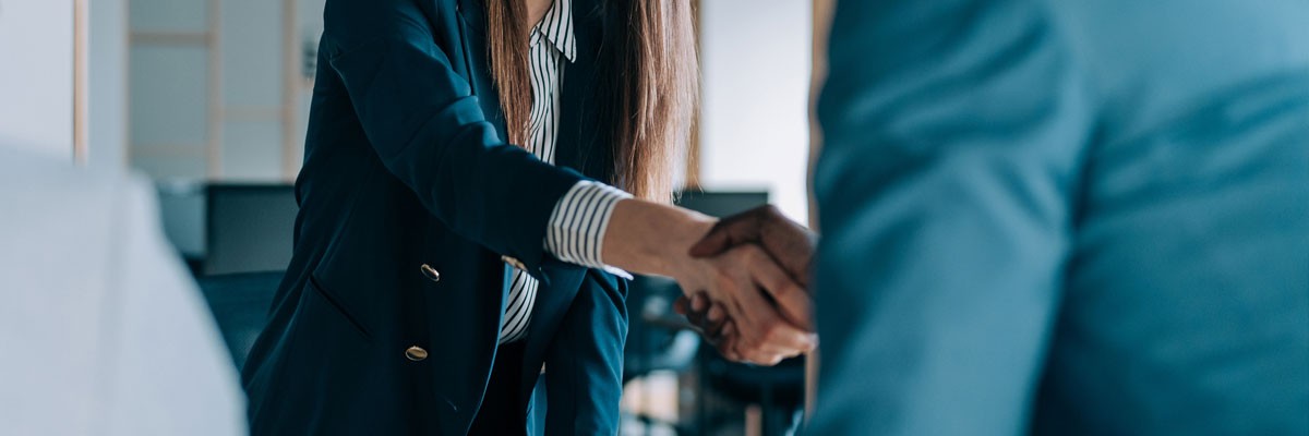 Prospective employee shakes hands with hiring manager