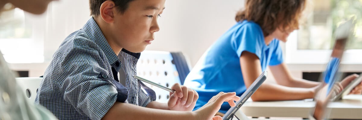 Young student on learning device
