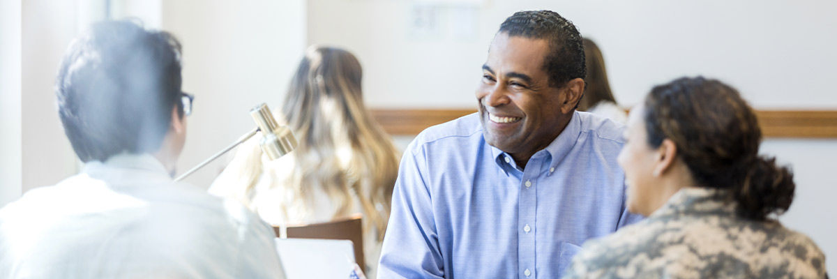 Man smiling with clients
