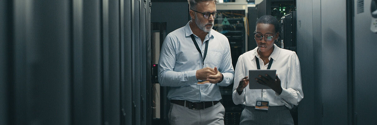 People in IT room with a tablet