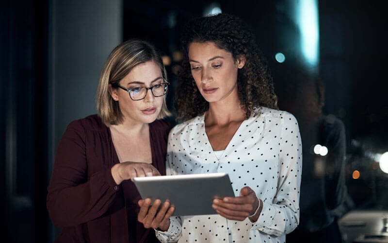 Two women looking at tablet