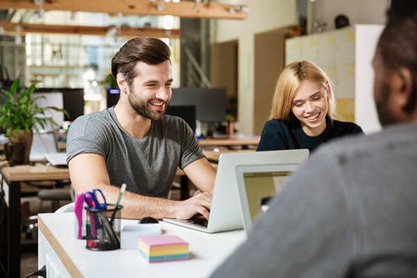 Read the ebook to learn more about topics like Intel Optane memory Coworkers working on their laptops