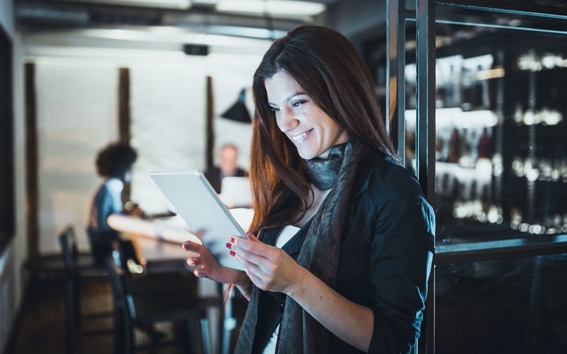 Today’s modern workforce is mobile, connected, inspired and secure Businesswoman on tablet device in office