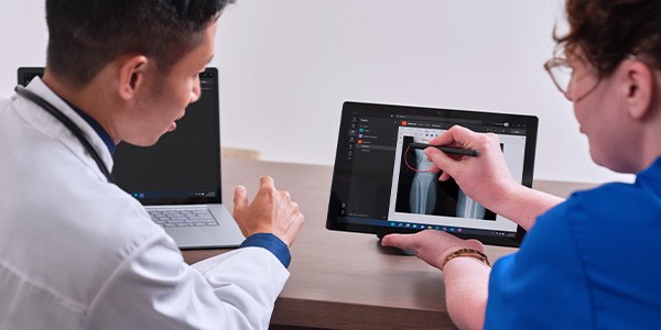 Redefine the patient and practitioner experience Doctor and nurse review patient data on Microsoft Surface