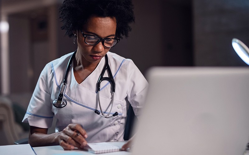 Smiling man reading report on tablet device