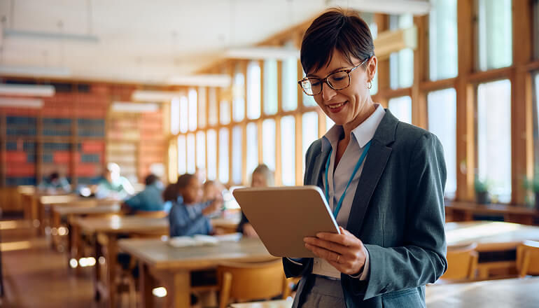 A blueprint for modern school IT: KIPP NYC creates a unified, collaborative environment for faculty and staff with K-12 Google Workspace migration Teacher smiling on tablet