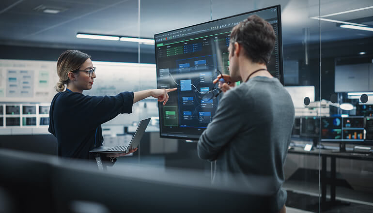 A new era of AI-powered security operations: How Thoughtworks empowered their security team to manage risk and focus on innovation People looking at a screen