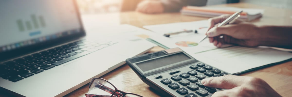 Artificial Intelligence Enhances Customer Experience Accountant using calculator and looking at pie chart