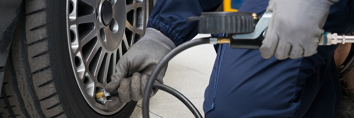 Creating Competitive Edge With an Industry-Leading Automated Tire Management System Mechanic filling tire