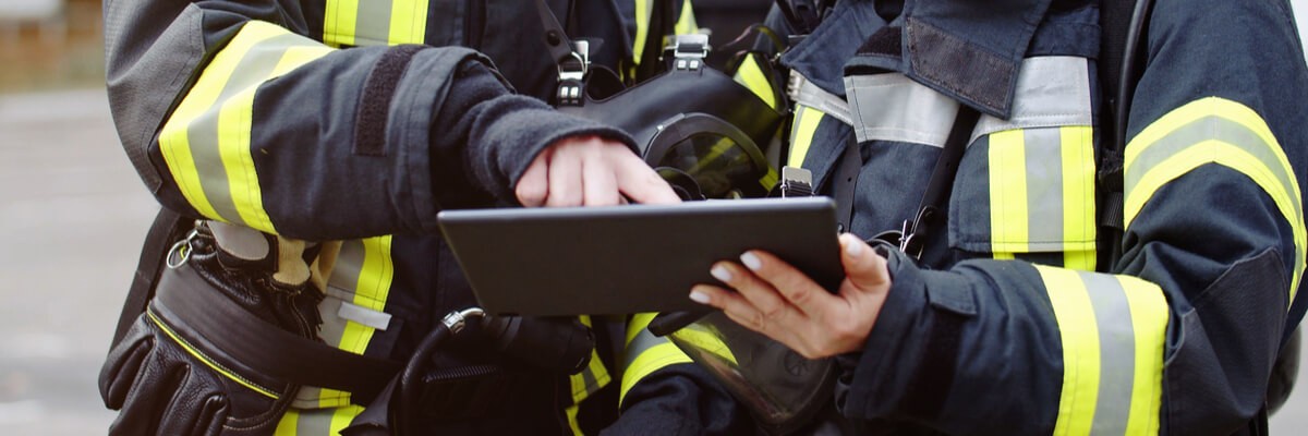 Fire Department Uses Real-Time Data to Improve Emergency Services Firefighters holding tech device