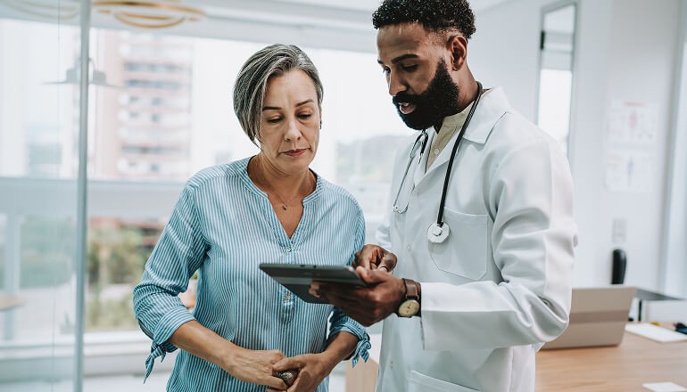 Doctor with patient looking at tablet