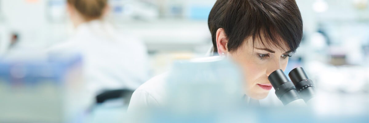 Pharmaceutical rep looking through magnifying glass