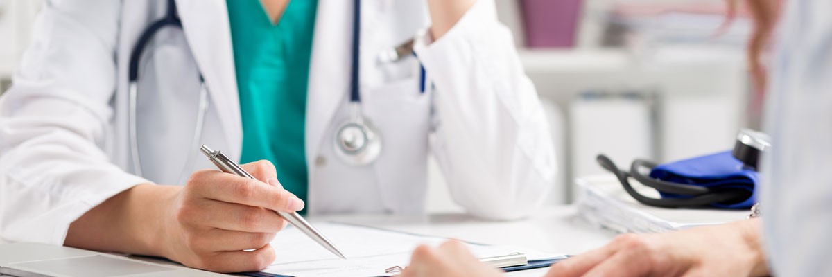 Close up view of doctor writing down patient data