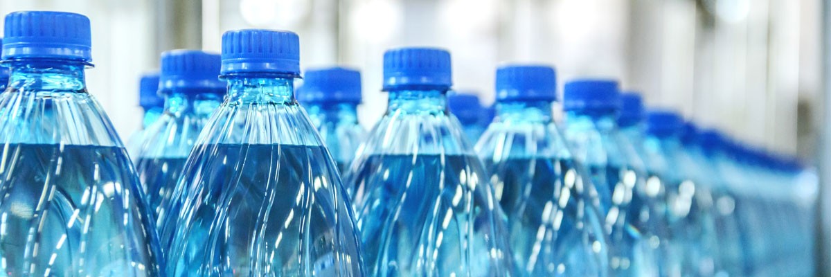 Close up of water bottle manufacturing on conveyor belt