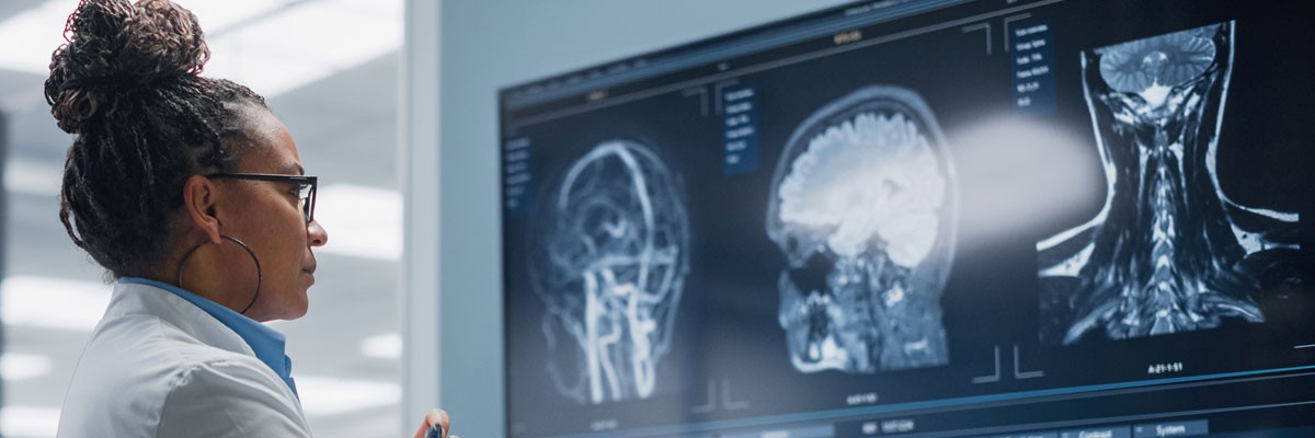 Doctor reviews x-ray results on large screen in hospital 