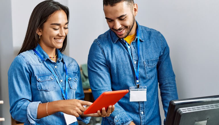 Shopkeepers using tablet computers in retail beauty stores for improved customer service