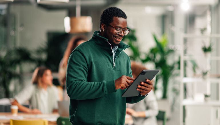 Salesloft Cuts Complexity by Migrating 1PB+ of Data to Google Cloud Man on laptop working.
