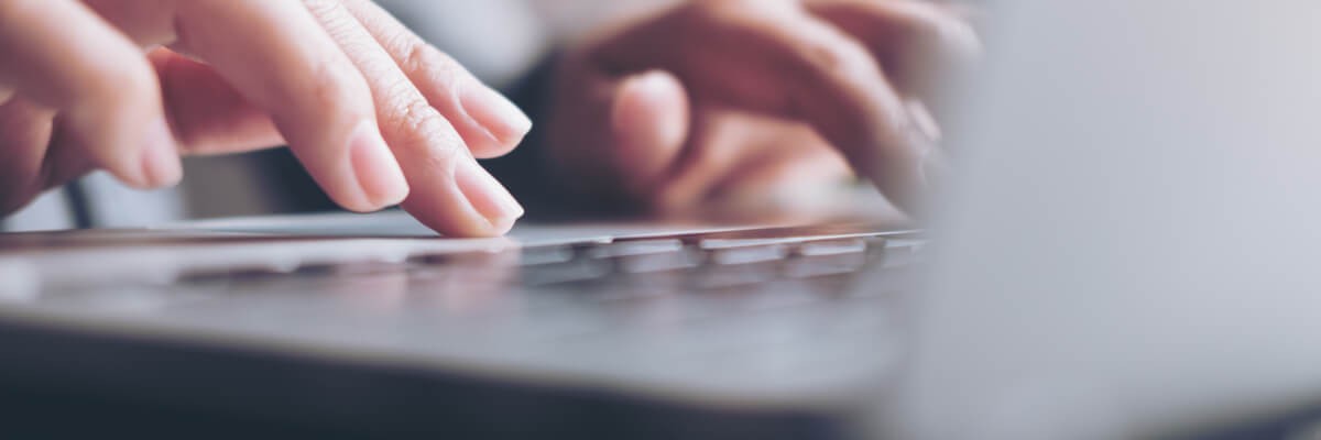 Hands typing on keyboard