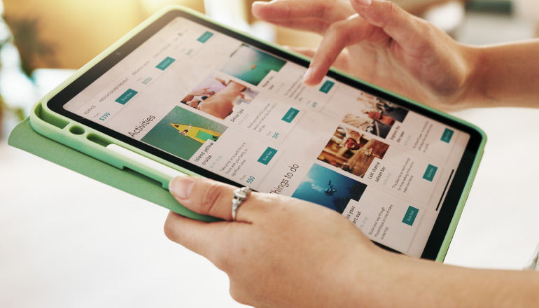 Sojern Optimizes Knowledge Access With Gemini Enterprise and Intelligent Search to Accelerate Travel Marketing Person on a tablet scrolling