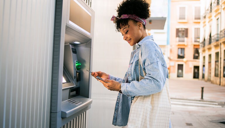 Tassat streamlines $24 trillion B2B bank payments market with blockchain-based solution on Google Cloud Girl using an atm