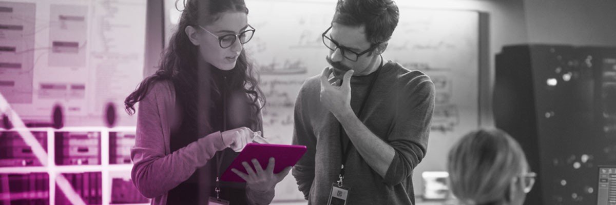 Two business professionals looking at tablet device